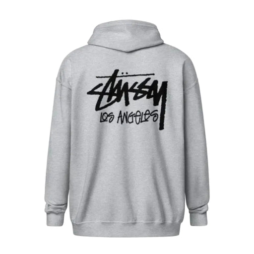 A light gray heather pullover hoodie shown from the back, featuring a large black Stussy Los Angeles logo printed across the upper back.