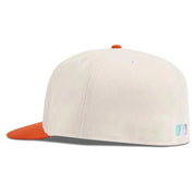 White cap with orange brim on a white background